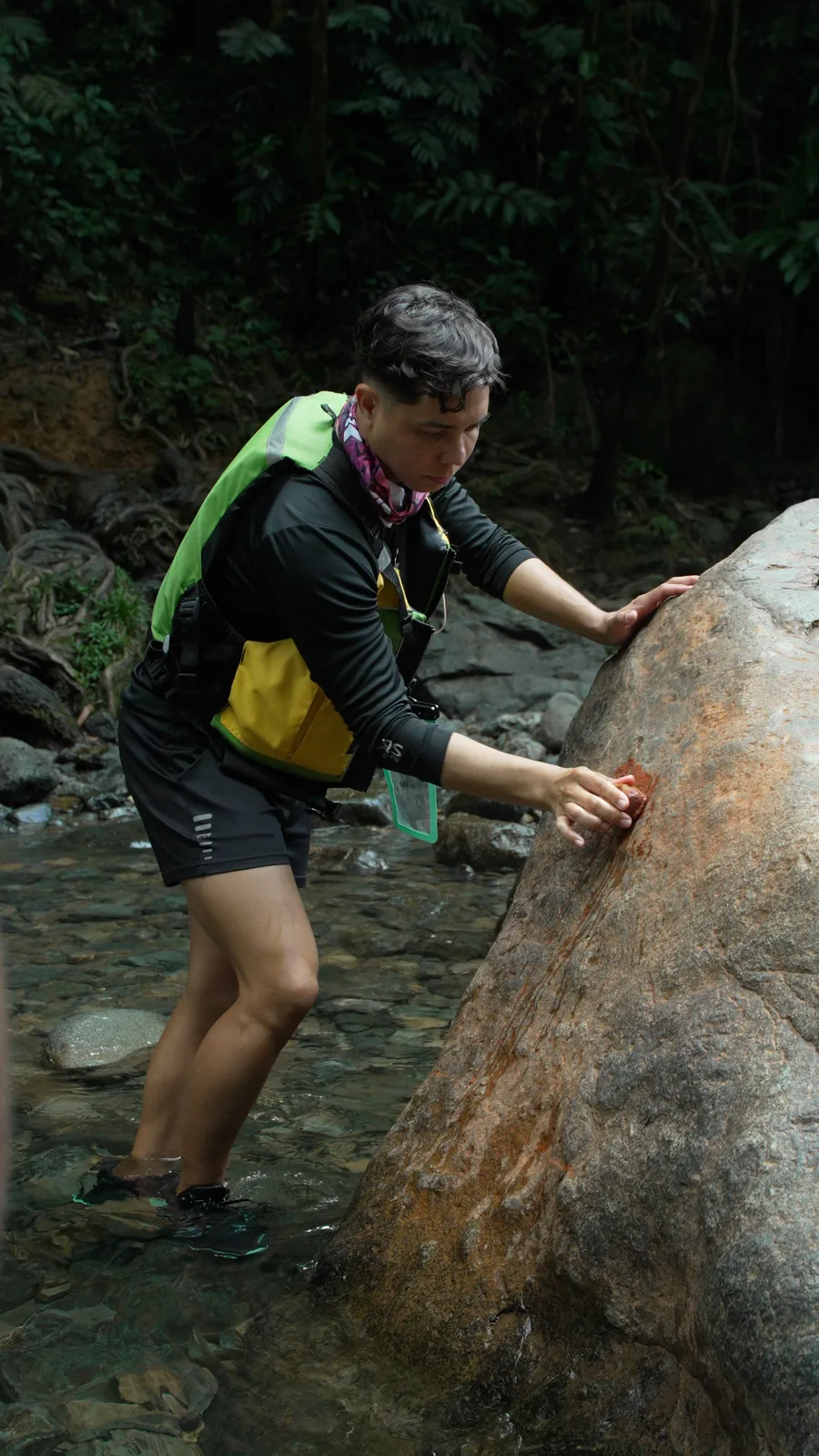Local Tours To Do PR guide navigating a clear rainforest stream during an El Yunque tour