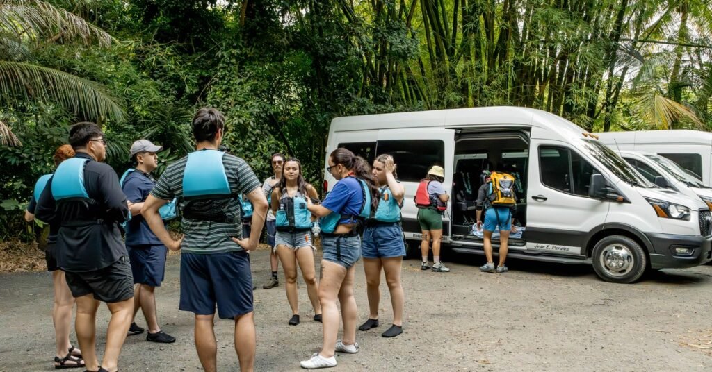 Tour group boarding a van in El Yunque National Forest after arriving from San Juan